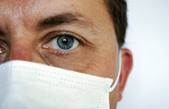 Bildet viser et ansikt med munnbind.