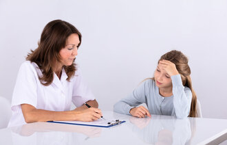 En ung jente i samtale med helsepersonell