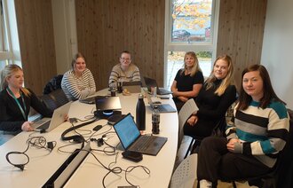 Bildet viser et evalueringsmøte med studenter