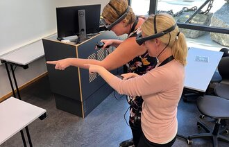 Bildet viser to jordmorstudenter som bruker MR-briller