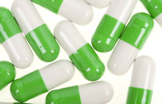 Bildet viser kapsler som er grønne og hvite.