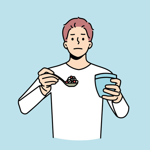 Illustrasjonen viser en mann med en skje full av piller.