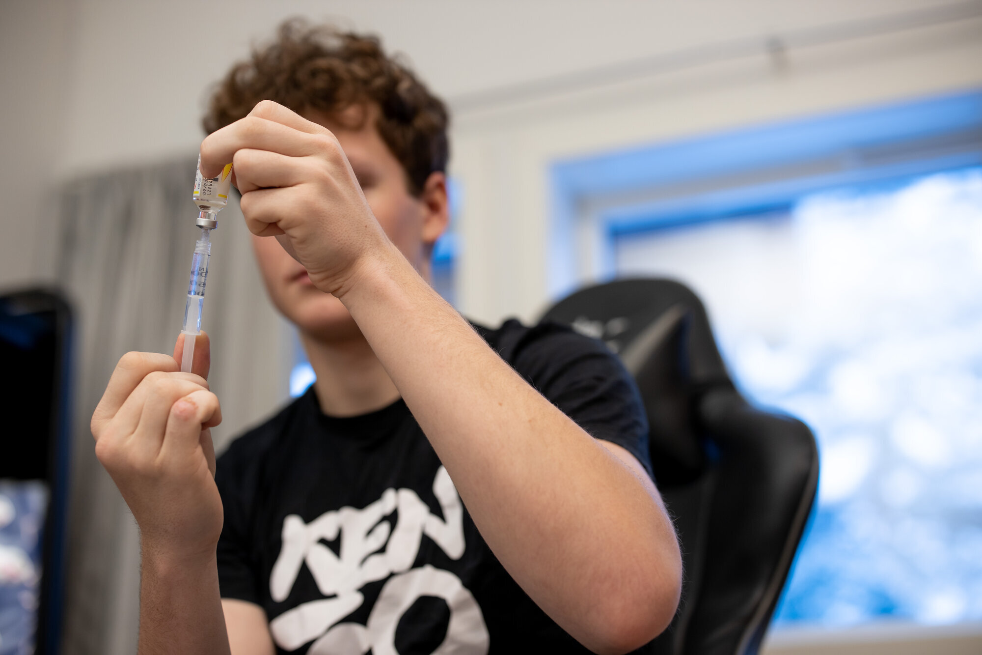 En gutt holder en insulinpenn