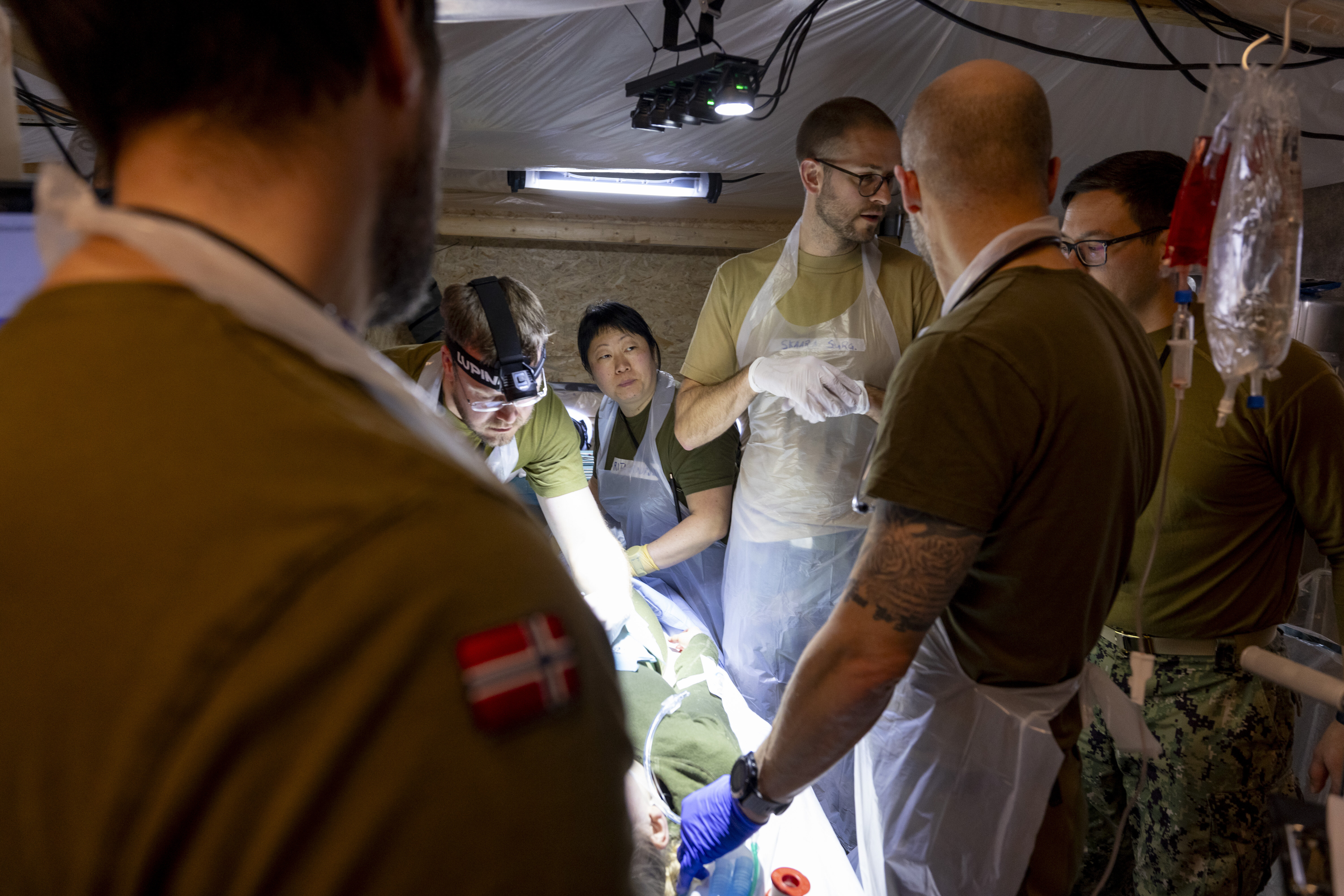Bildet viser operasjonsteam på operasjonsstue i feltsykehus.