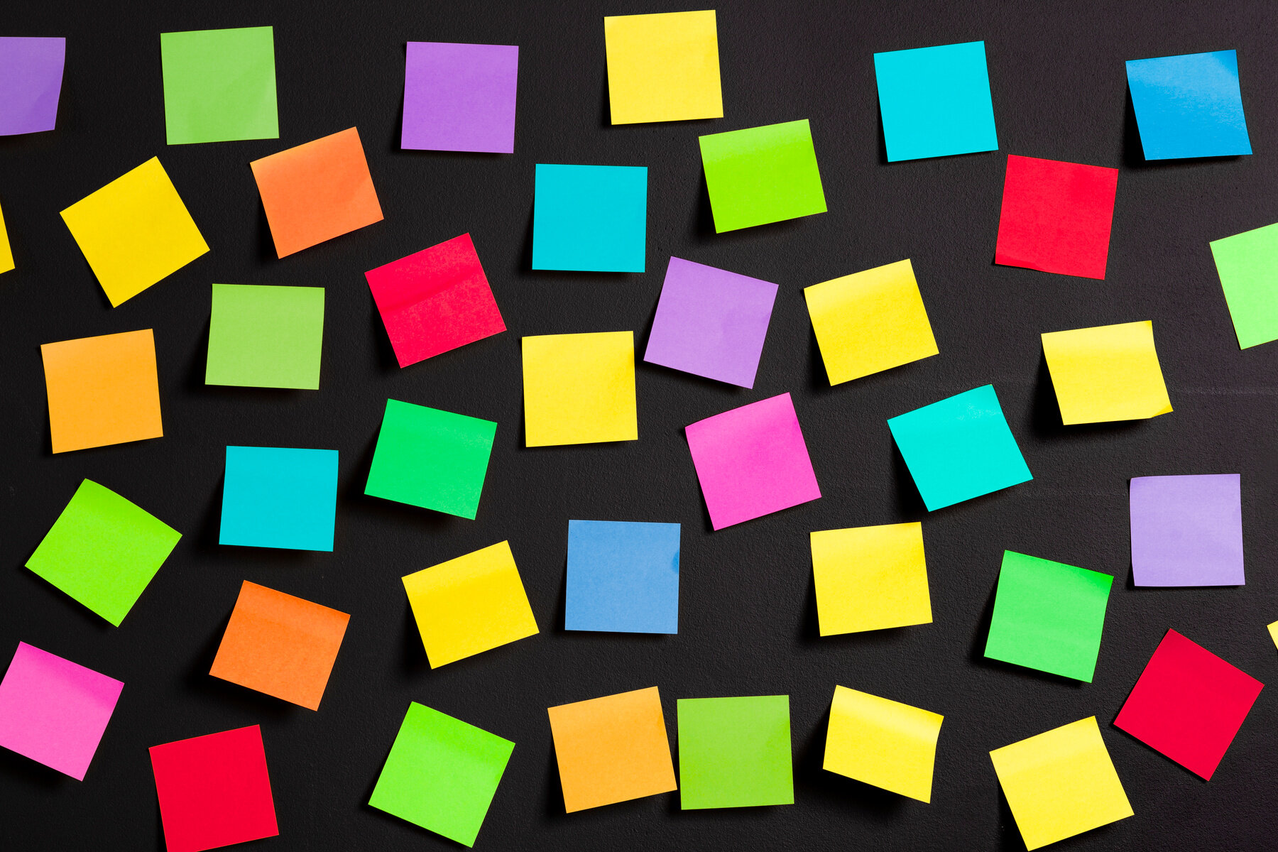Bildet viser mange post-it lapper på svart bakgrunn