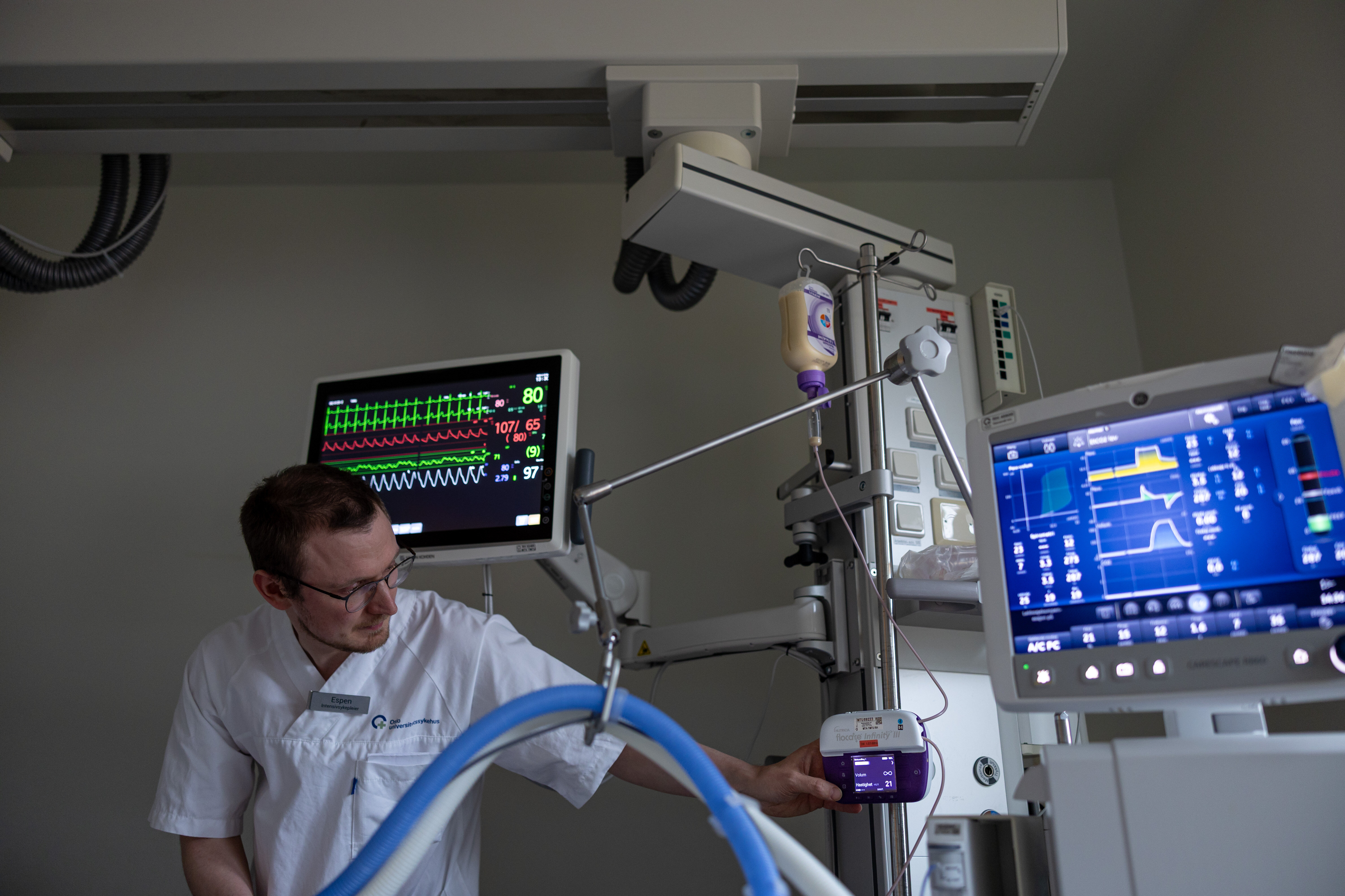 The picture shows a nurse preparing equipment for enteral nutrition in the intensive care unit.