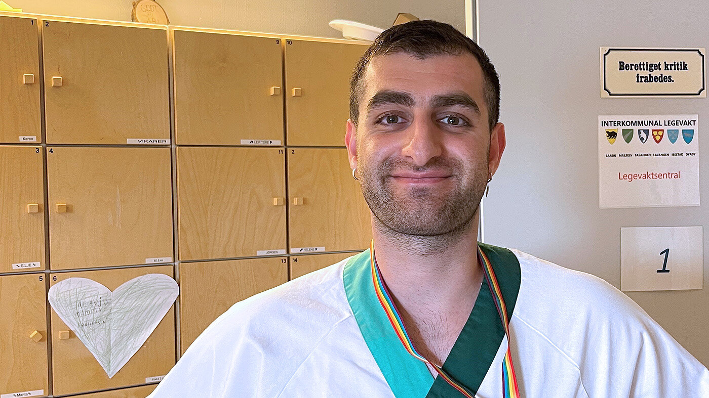 Bildet viser Robert Kotcho på jobb i sykepleieruniform.