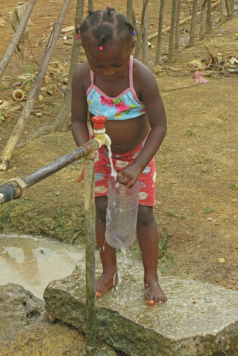 Jente fyller vann på flaske