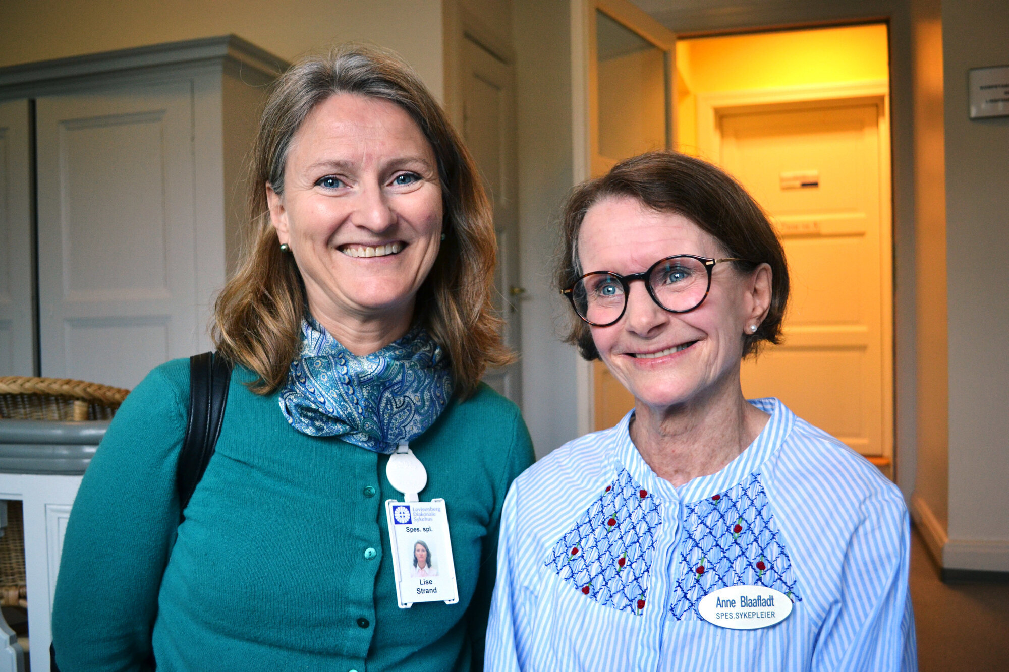 Sykepleierne Lise Trand og Anne Blaafladt smiler og ser i kamera