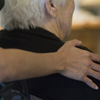 En sykepleier holder rundt en eldre kvinne